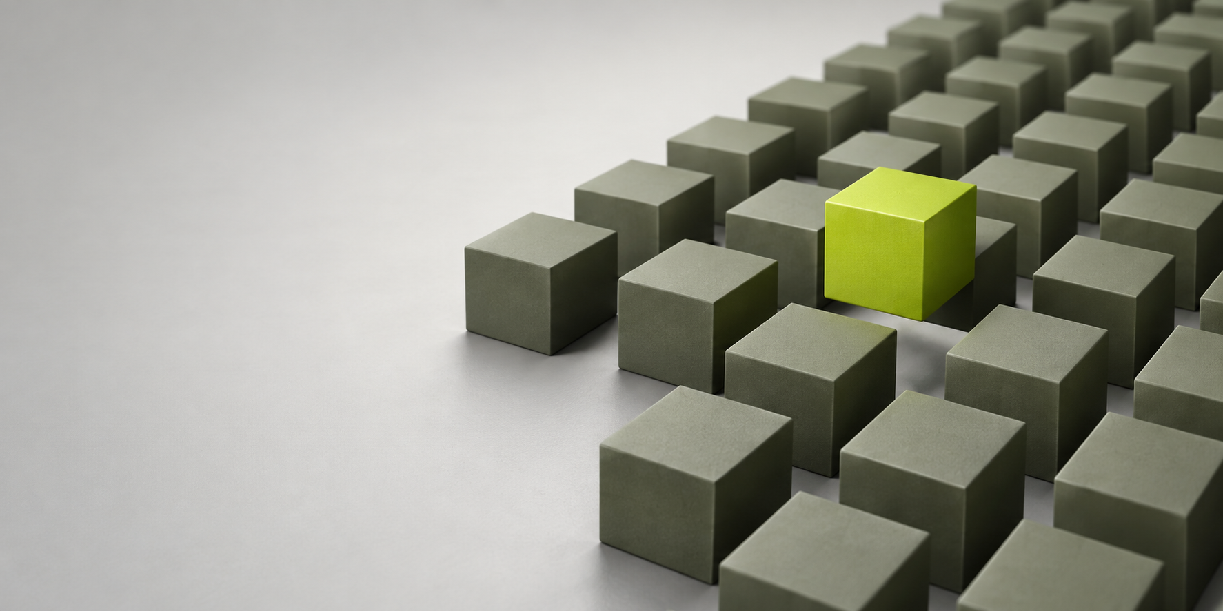 A bright lime-green cube stands out among grey-green cubes.